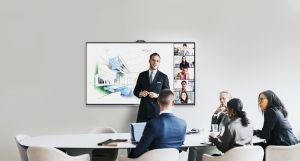 An employee using an interactive whiteboard to lead a professional presentation in a modern conference room.