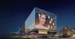 : A modern building featuring an LED transparent film installation on its glass façade to display vibrant digital content.