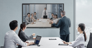 professional team in Singapore collaborating via an interactive smart whiteboard integrated with a high-definition video conferencing system.